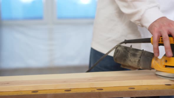 Carpenter Working on Wood Grinding Machine