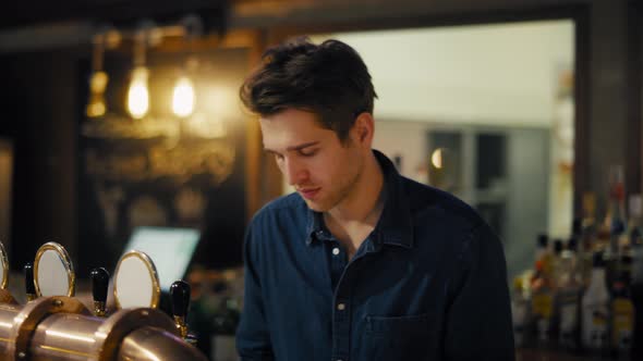 Portrait of caucasian bartender at work. Shot with RED helium camera in 8K.