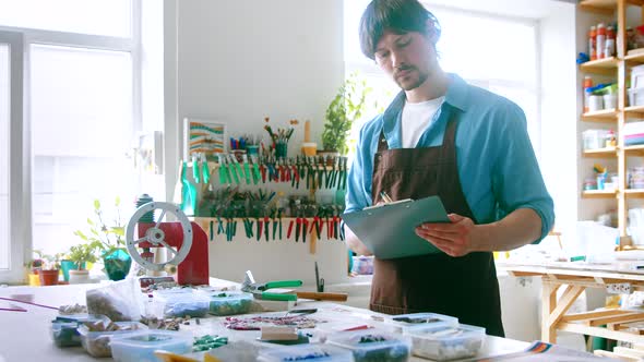 A young master conducting inventory in a creative studio