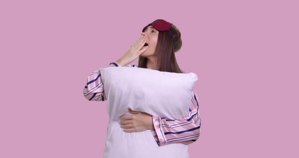 Young Female with a Pillow and Pyjamas Boring and Falling a Sleep, Isolated