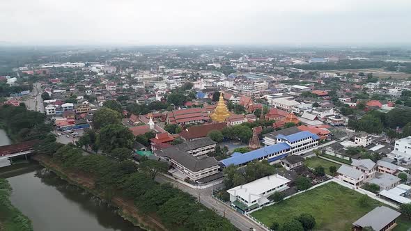 Aerial Footage of Wat Phra That Hariphunchai, The Famous Buddhist temple in Lamphun, Thailand, Surro