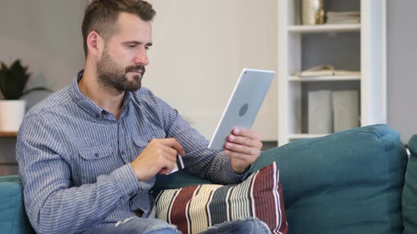 Successful Online Payment on Tablet by Casual Man