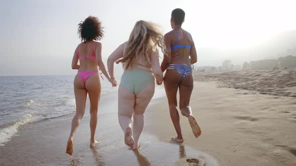 young women having fun on the beach