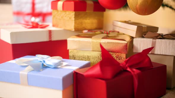 Closeup Footage of Lots of Colorful Boxes with Gifts and Presents Decorated with Ribbons and Bows