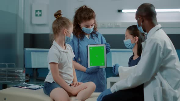 Woman Nurse Analyzing Digital Tablet with Green Screen