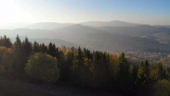 Flight Over Autumn Mountains in The Light of The Setting Sun.