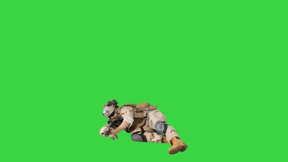 Soldier Firing From Lying Position on a Green Screen, Chroma Key