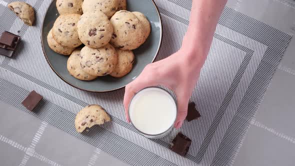 Glass of Milk and Chocolate Chip Cookies on the Kitchen Table