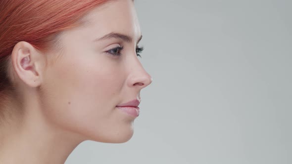 Studio portrait of young, beautiful and natural redhead woman. Beauty concept.