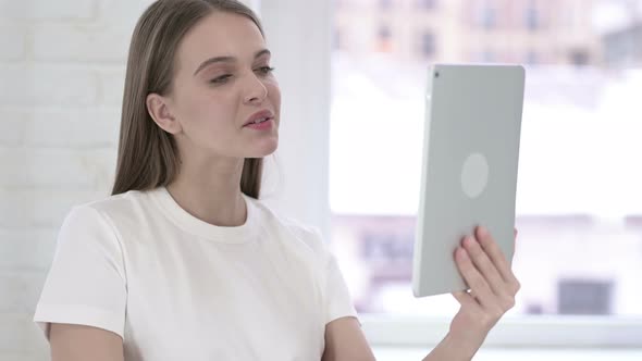 Portrait of Beautiful Young Woman Doing Video Chat on Tablet