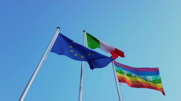 Europe Italian and Peace Flags on Blue Sky Background
