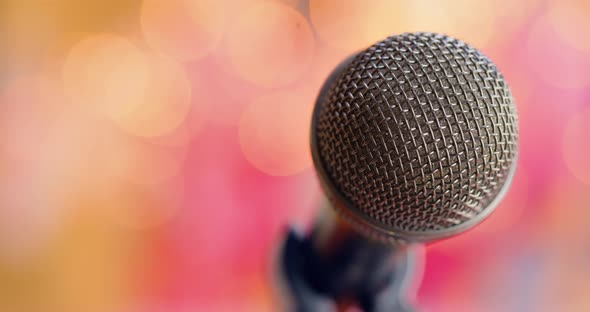 Microphone on Stage Against a Blurry Light Blurry Background