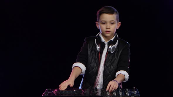 Teenager Dj in Leather Jacket Playing on Vinyl. Black Background