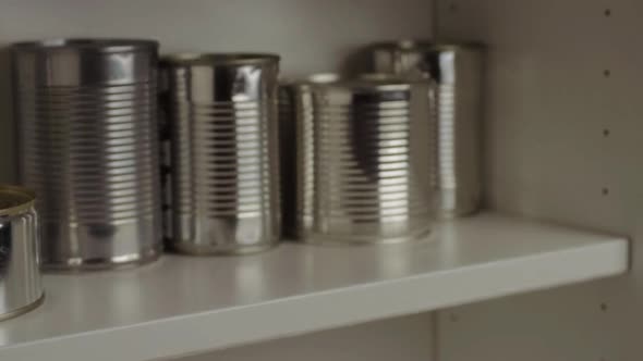 Getting aluminum tin cans  out of food cupboard shelf