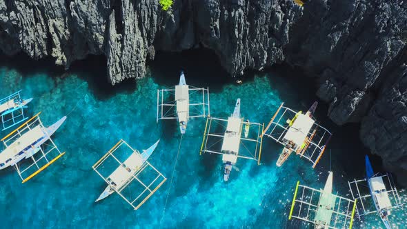 Aerial Drone View of Swimmers Inside a Tiny Hidden Tropical Lagoon Surrounded By Cliffs - Secret