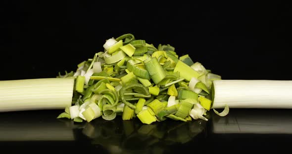 Cutting Leek Onion on Black Background