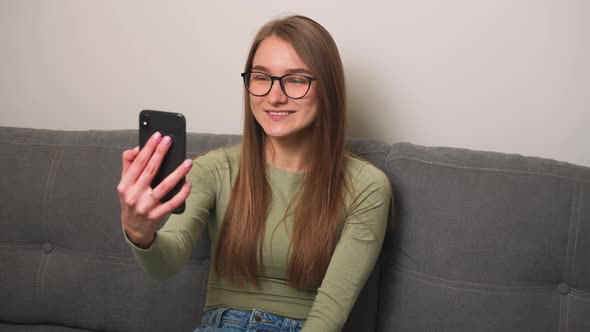 Smiling Woman Having Video Call on Smartphone Friendly Woman Waving Hand at Camera Pretty Woman