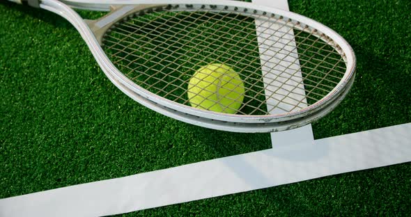 Tennis ball and racket near white line 4k