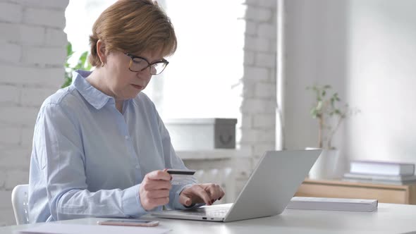 Online Shopping with Credit Card on Laptop By Old Woman, Payment