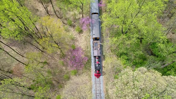 Aerial Down Angle View of an 1860's Steam Passenger Train Traveling