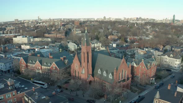Aerial Drone Shot Crossing a Street Towards a Brick Church in Suburban Boston