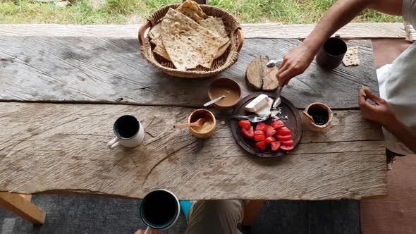 Social Communication in Dining Table in Morning Breakfast Time with Wooden Table, Basket, Flat Bread