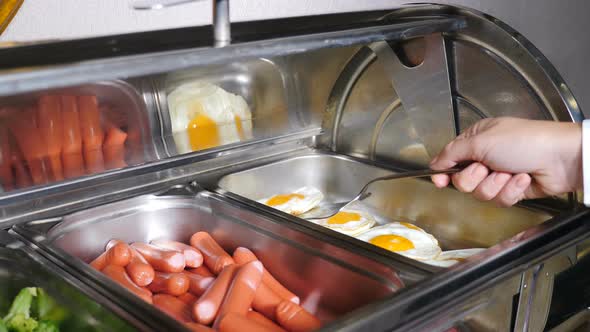 Buffet Heated Trays with Sausages, Boiled Broccoli and Fried Eggs in Hotel Luxury Restaurant. All