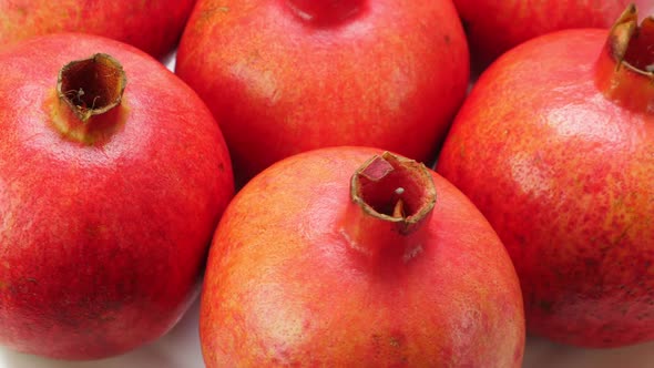 A Lot of Ripe Red Whole Pomegranates. Rotating