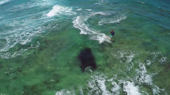 Aerial view of a man kitesurfing in Hawaii