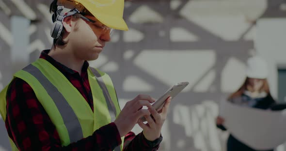 Confident Young Male Contractor Using Digital Tablet