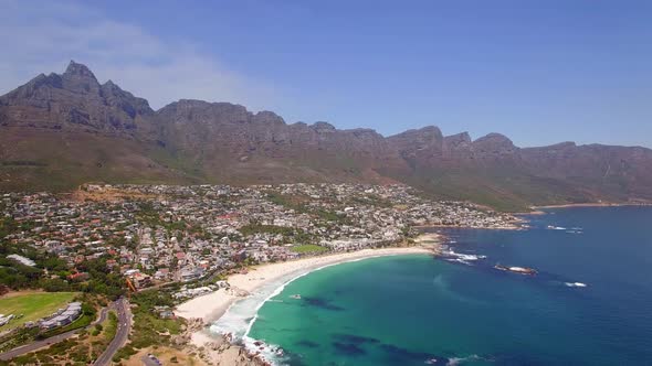 Aerial travel drone view of Camps Bay beach, Cape Town, South Africa.