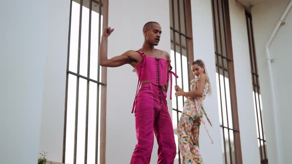 Man in Pink Clubwear Parading Passed Dancing Woman