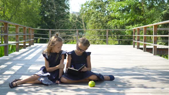 Adorable Little School Girls with Notes and Pencils Outdoor, Back To School