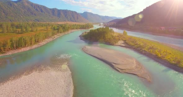 Low Altitude Flight Over Fresh Fast Mountain River with Rocks at Sunny Summer Morning.