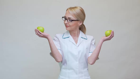 Nutritionist Doctor Healthy Lifestyle Concept - Holding Two Organic Green Apples