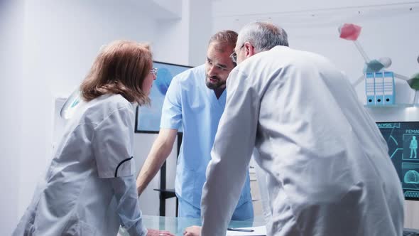 Group of Scientists and an Assitant Are Talking