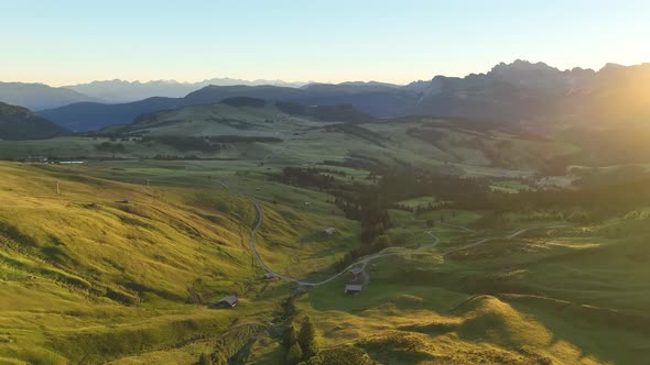 Dolomites mountains peaks with a hiking path on a summer sunrise