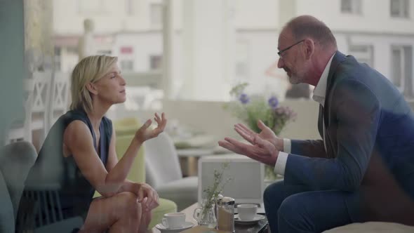 Businessman and woman having a meeting in coffee shop