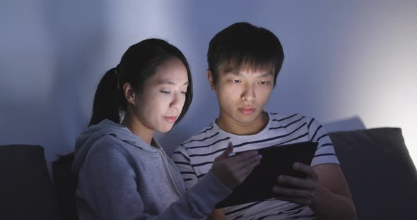 Couple Watching on Tablet Computer at Home