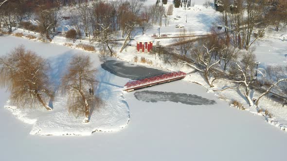 An Island on a Lake with a Bridge in the Winter Loshitsky Park