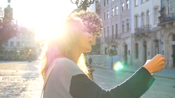 Female Portrait of a Woman Tourist with Sunglasses and Paper Map in Her Hands Searching for