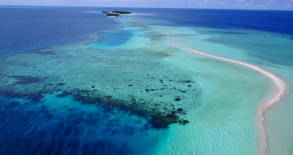 Natural fly over abstract shot of a sandy white paradise beach and blue ocean background 