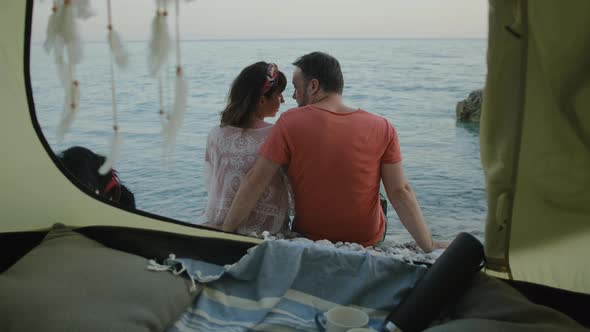 View from the tent  on Lovely Couple looking at sea through dream Catcher  with Adorable dog