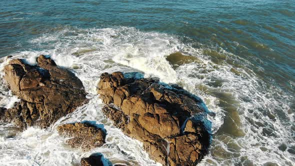 Great Aerial View of Large Ocean Waves Crashing Against Rocks