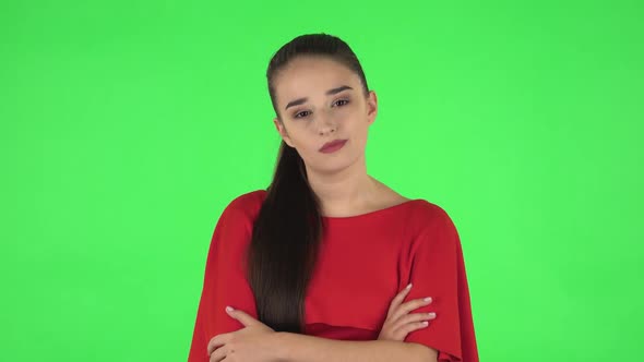 Portrait of Pretty Young Woman Communicates with Someone in a Friendly Manner. Green Screen