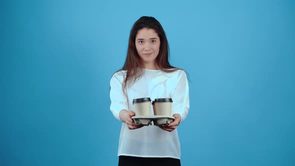 The Smiling Young Woman Spreads Out Four Glasses of Coffee Placed in a Holder