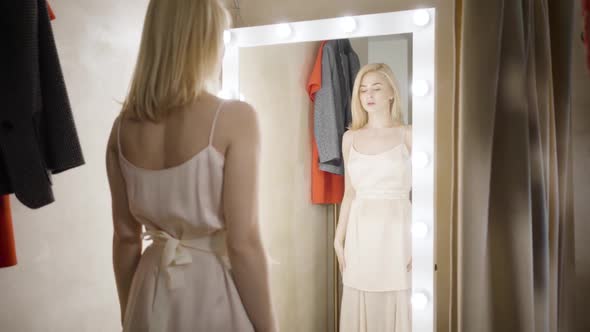Slowmo of Young Elegant Caucasian Woman Looking at Reflection in Dressing Room. Confident Rich Lady