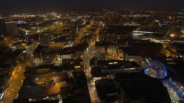 Aerial flyover of Belfast City Centre and Lagan River at night