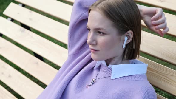 Relaxed Young Woman Blonde in White Wireless Headphones