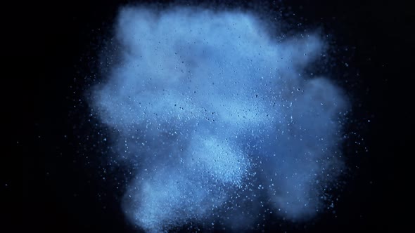 Blue powder/particles fly after exploded on black background. Slow Motion. 4K 30fps. Slow Motion.